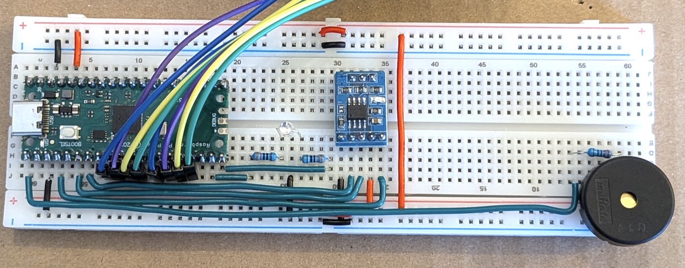 The buzzer at the far end, its ribbon wire running along the bottom edge