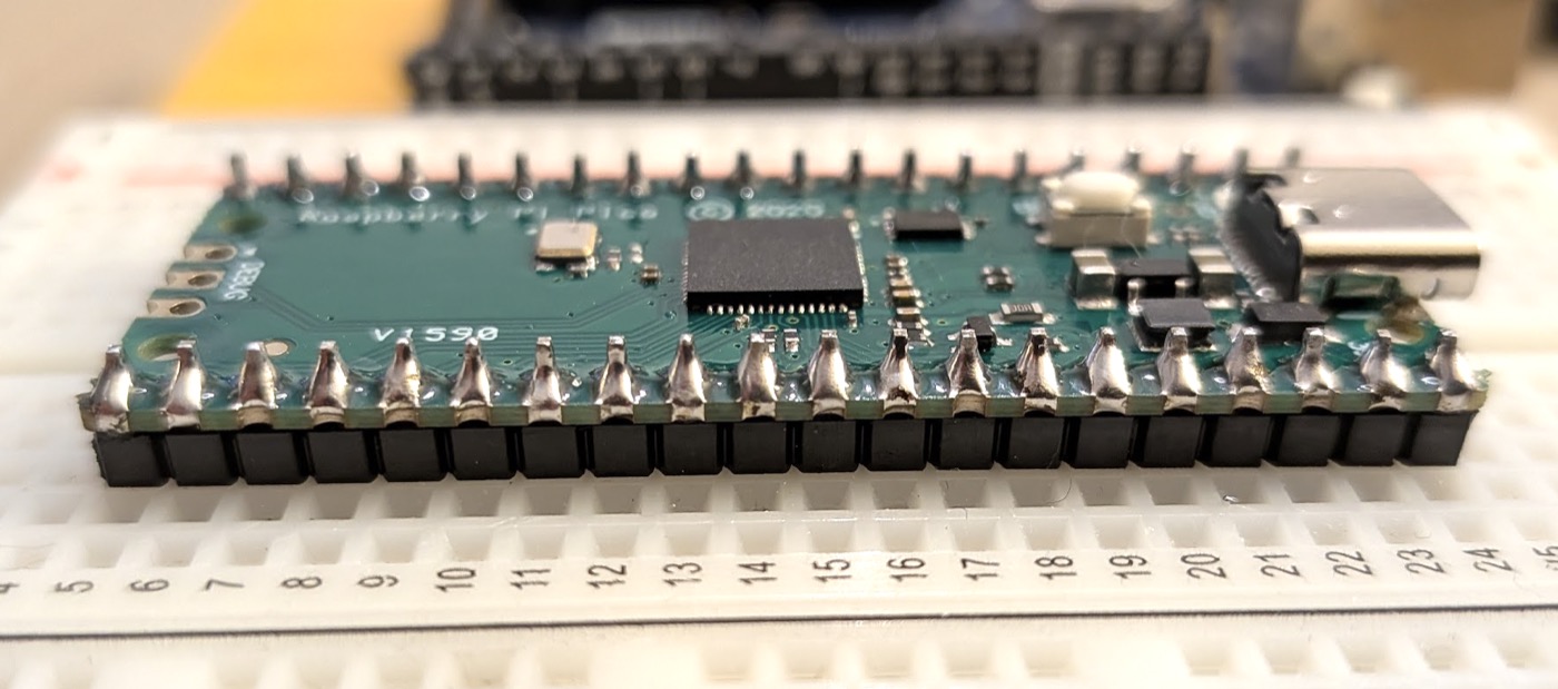 The Pico with its headers soldered, sitting in the breadboard