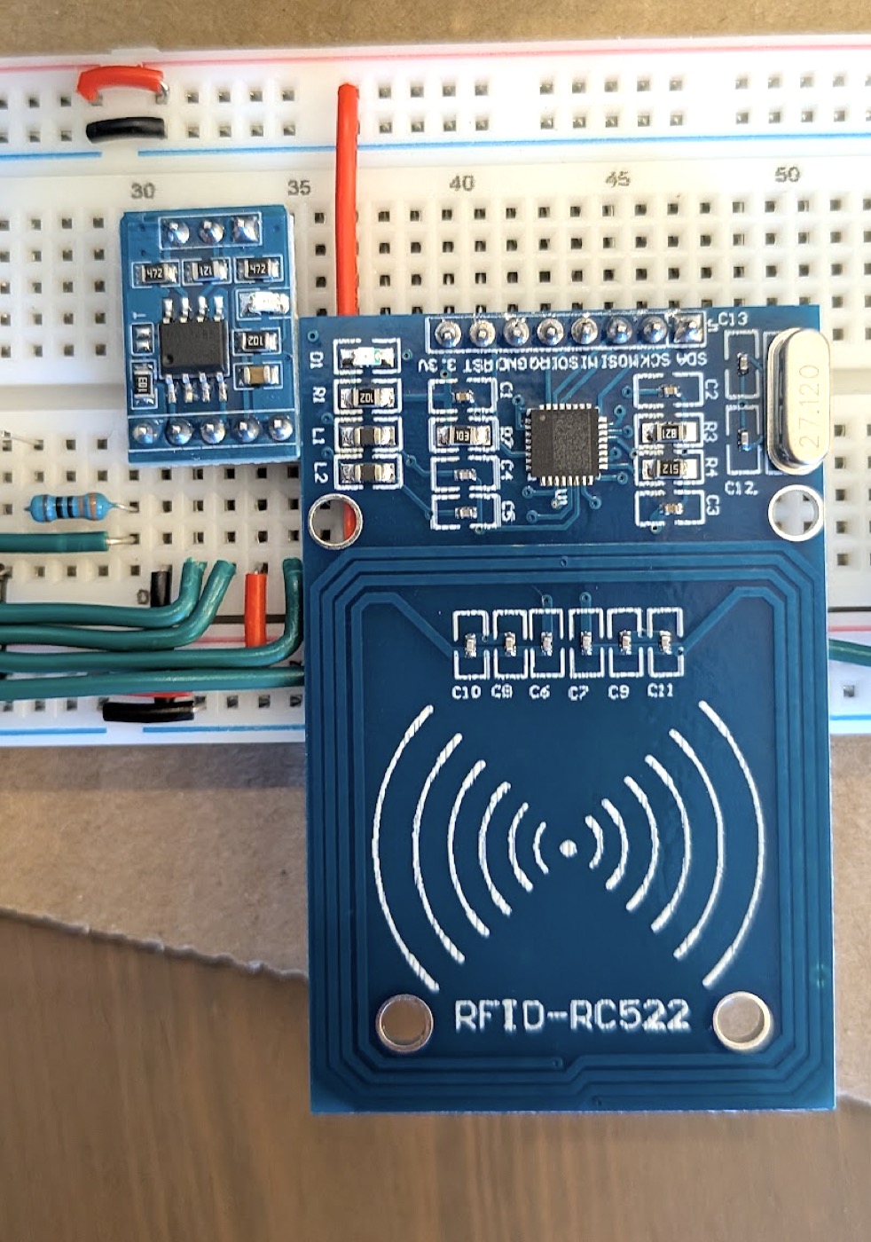 The RC522 planted upside down, its antenna past the edge of the board